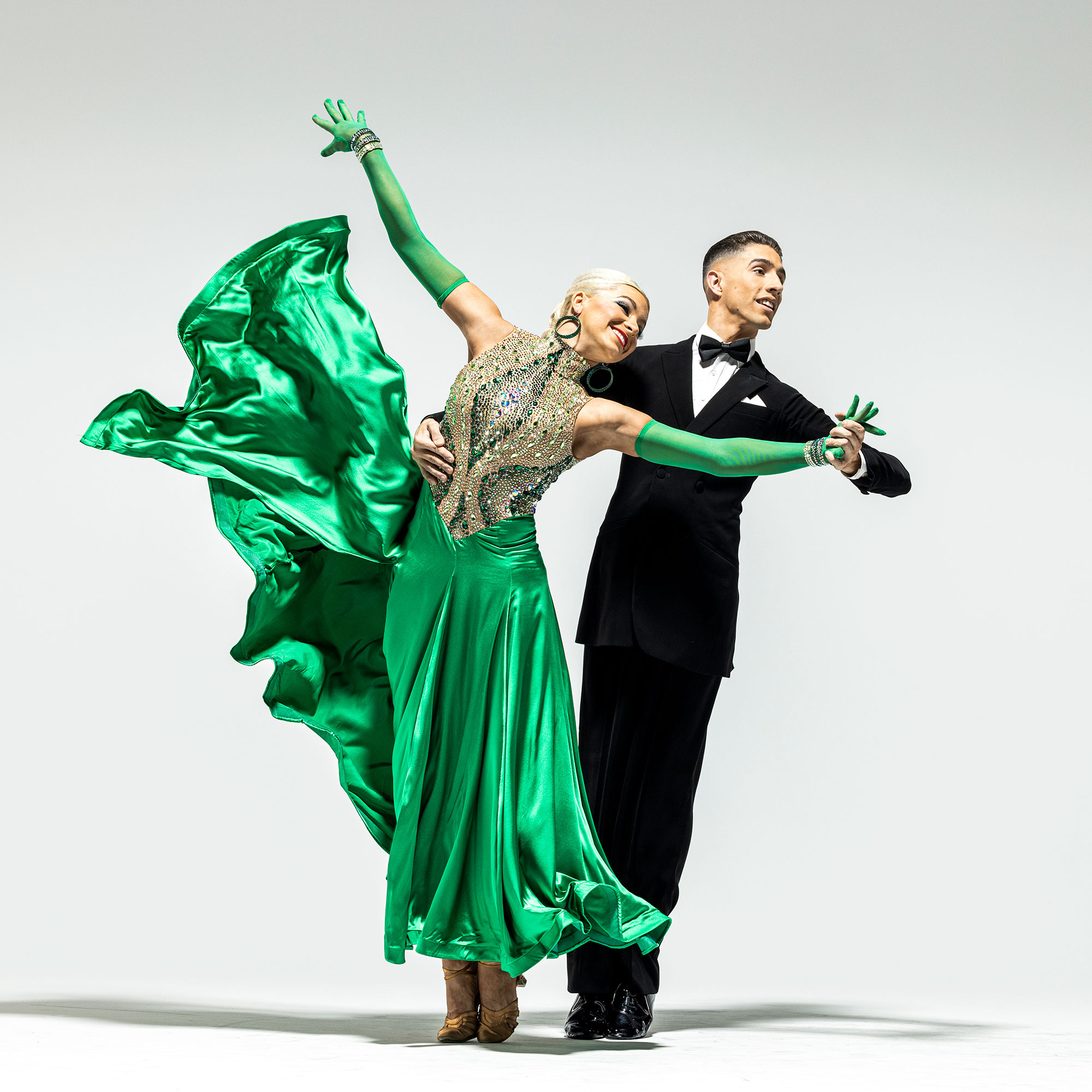 Ballroom dancers in sequins and tailcoats during a BYU show in Ogden