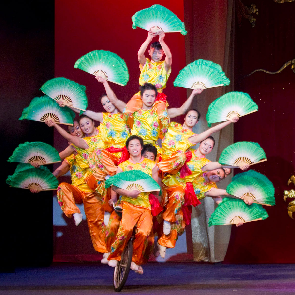 Peking Acrobats troupe performing precision tumbling with live Chinese musicians in Ogden