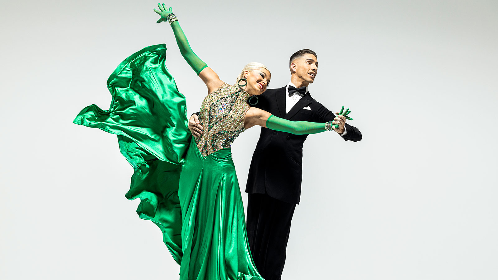 Ballroom dancers in sequins and tailcoats during a BYU show in Ogden